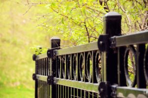 hercules fence aluminum fence with green trees in background